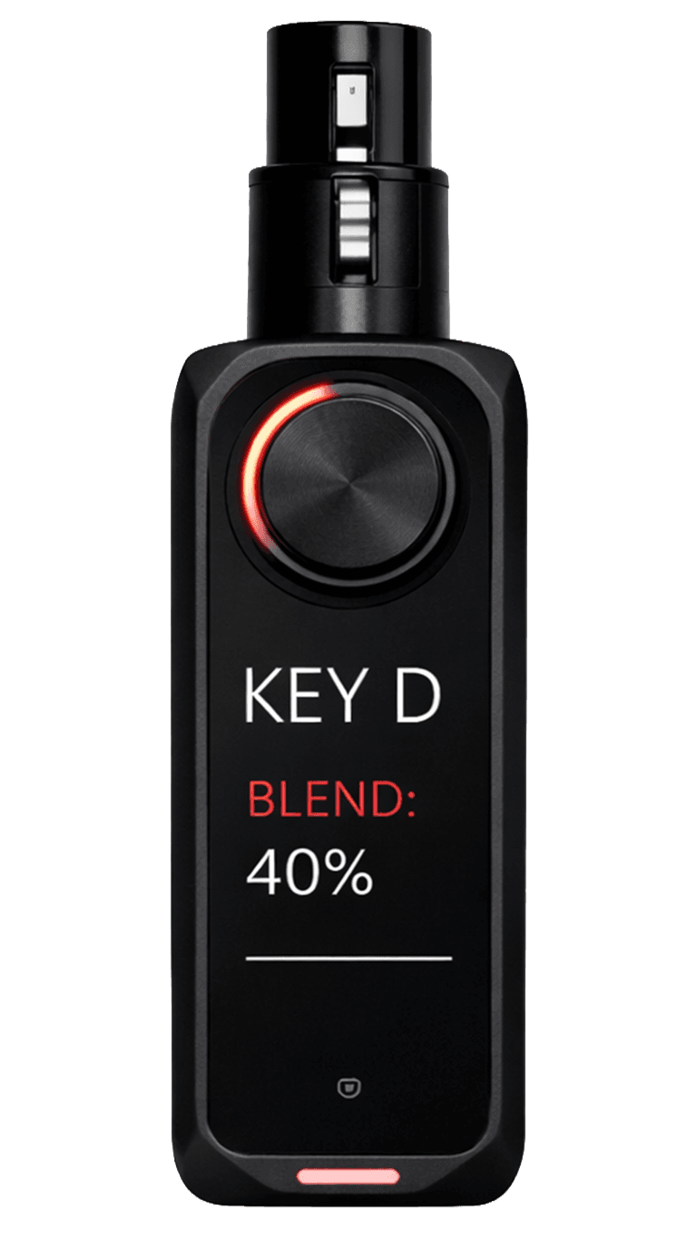 VOXCHAIN V1 device front detail — backlit rotary control and OLED display.